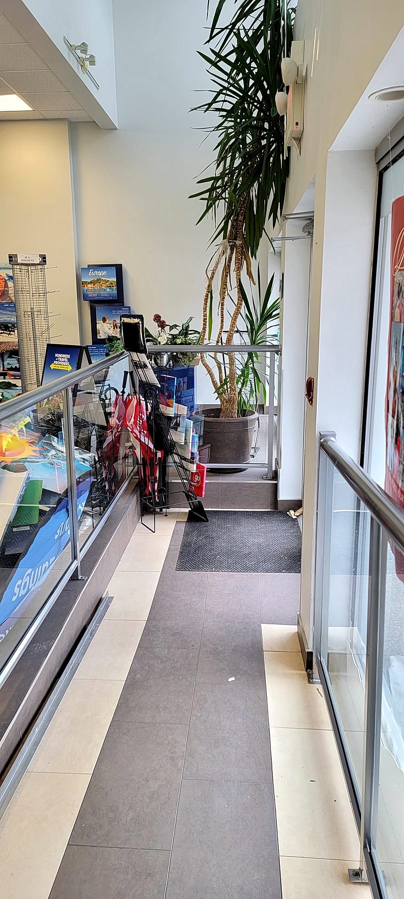 Old railings and carpet at the store entry before renovation