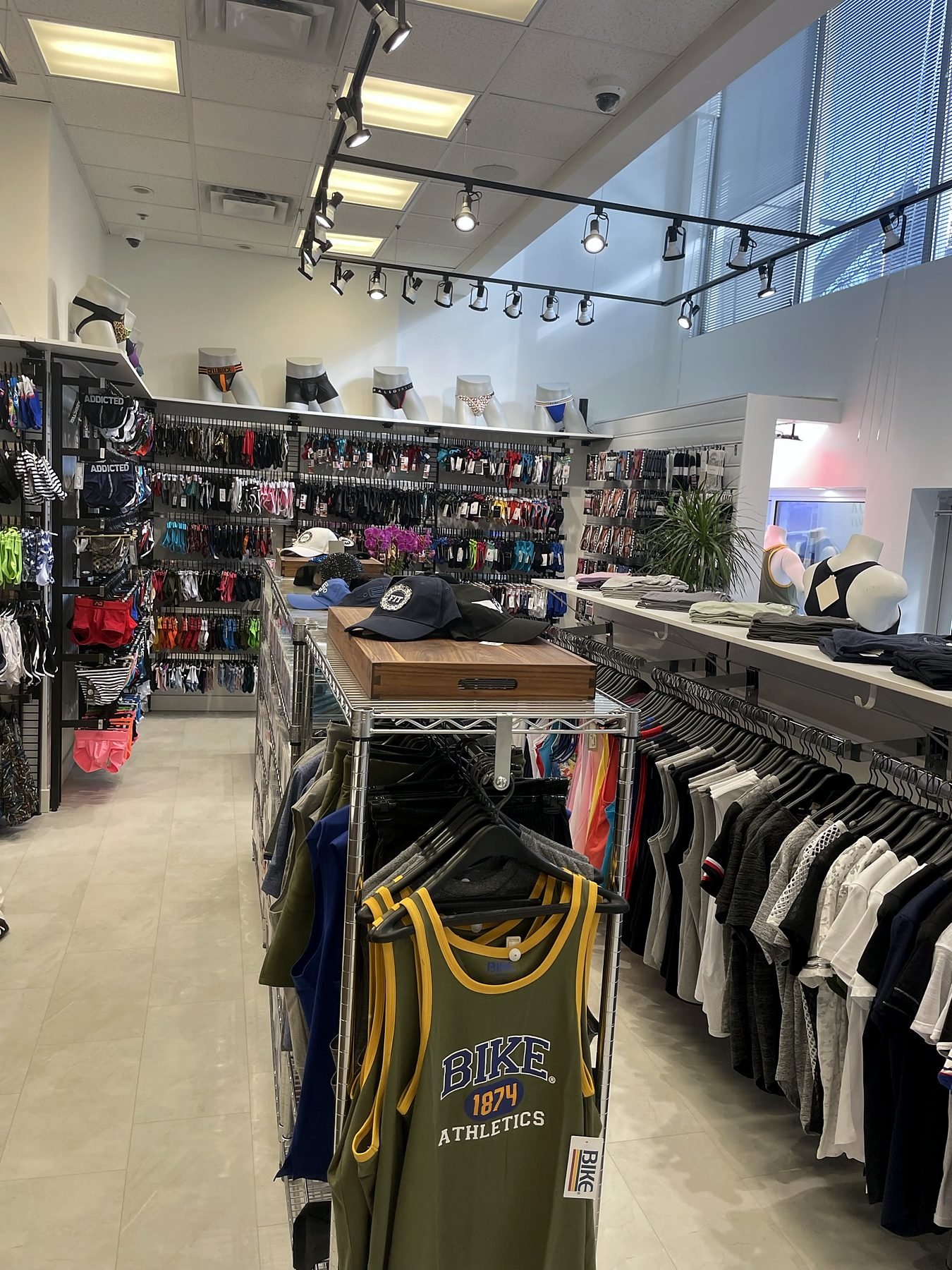 Clothing racks and display tables on the renovated retail floor of Top Drawers Apparel