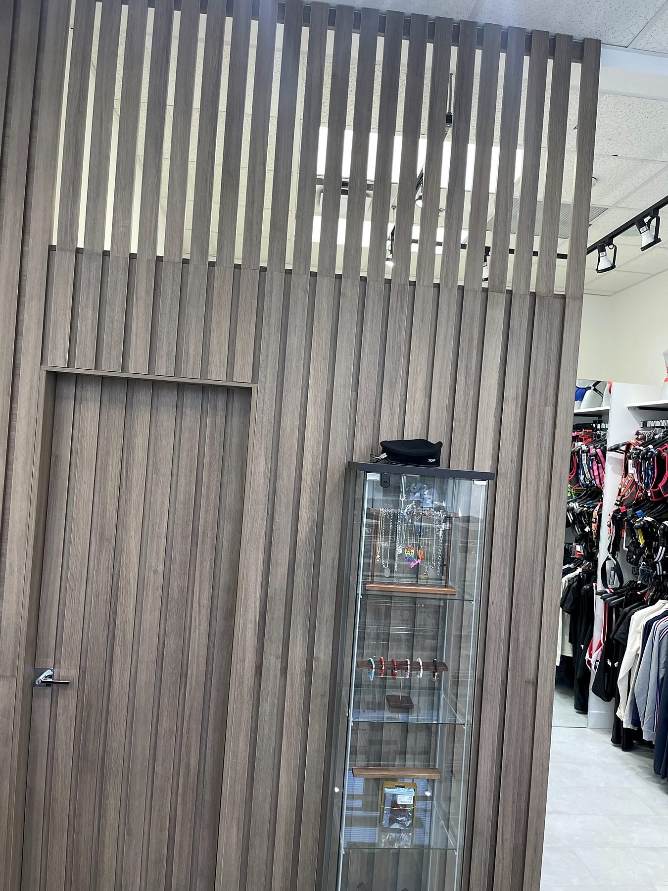 Custom wood slat feature wall with a hidden door to the staff area