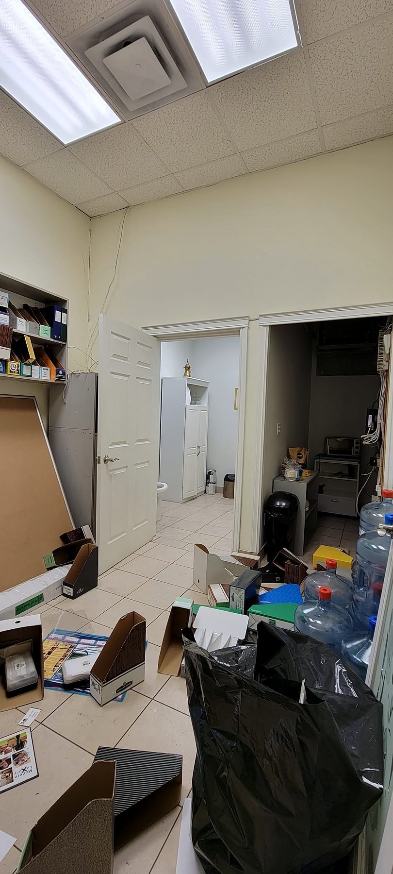 Retail unit on Hornby Street before renovation, used as a cluttered office and showroom