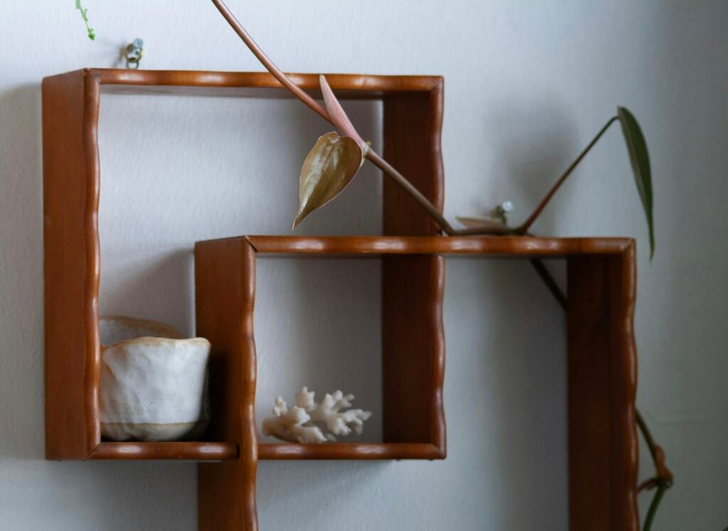 Wooden shelf with a plant and ceramic vase