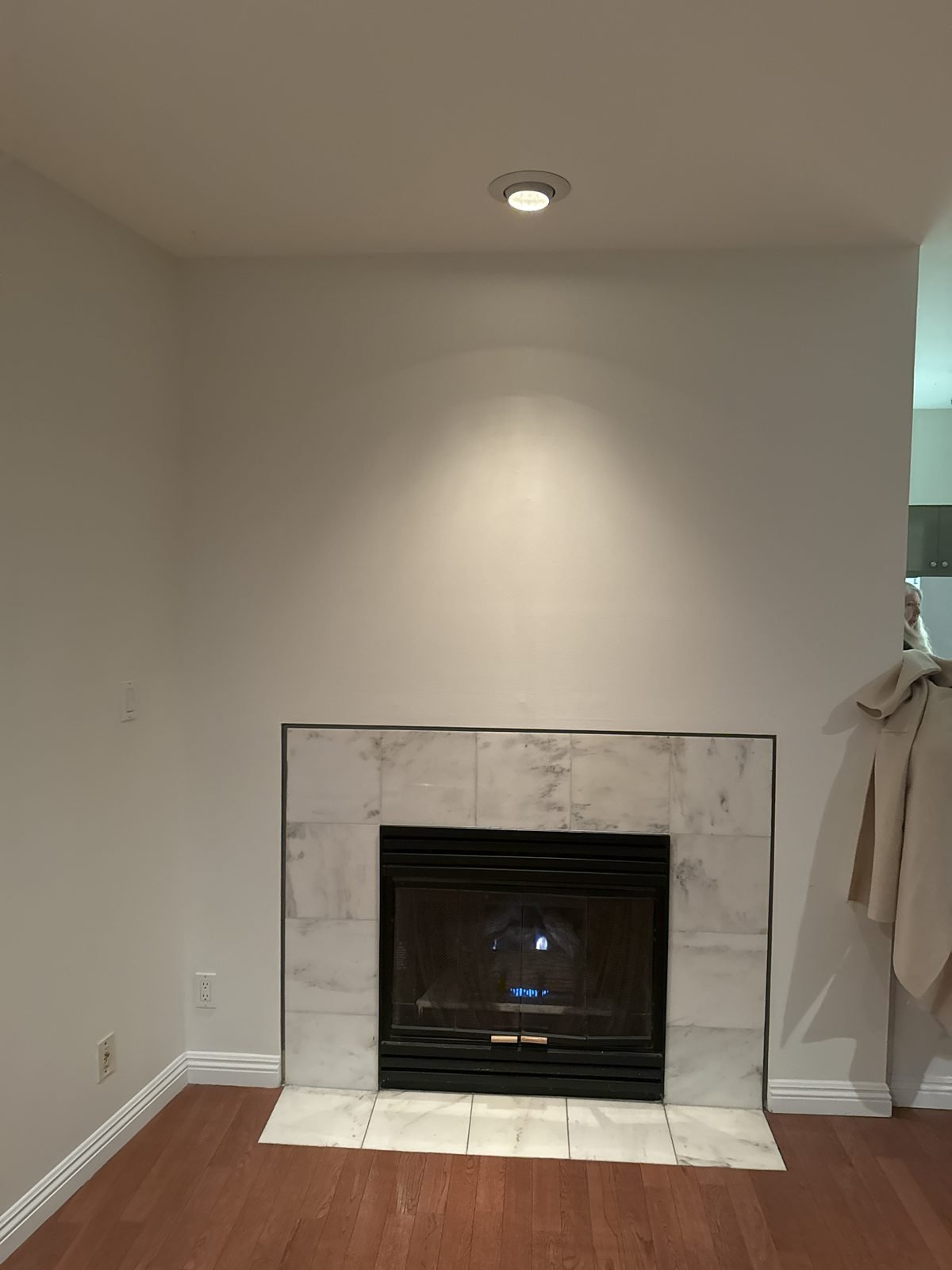 Before: fireplace with a tiled surround in a West End condo living room