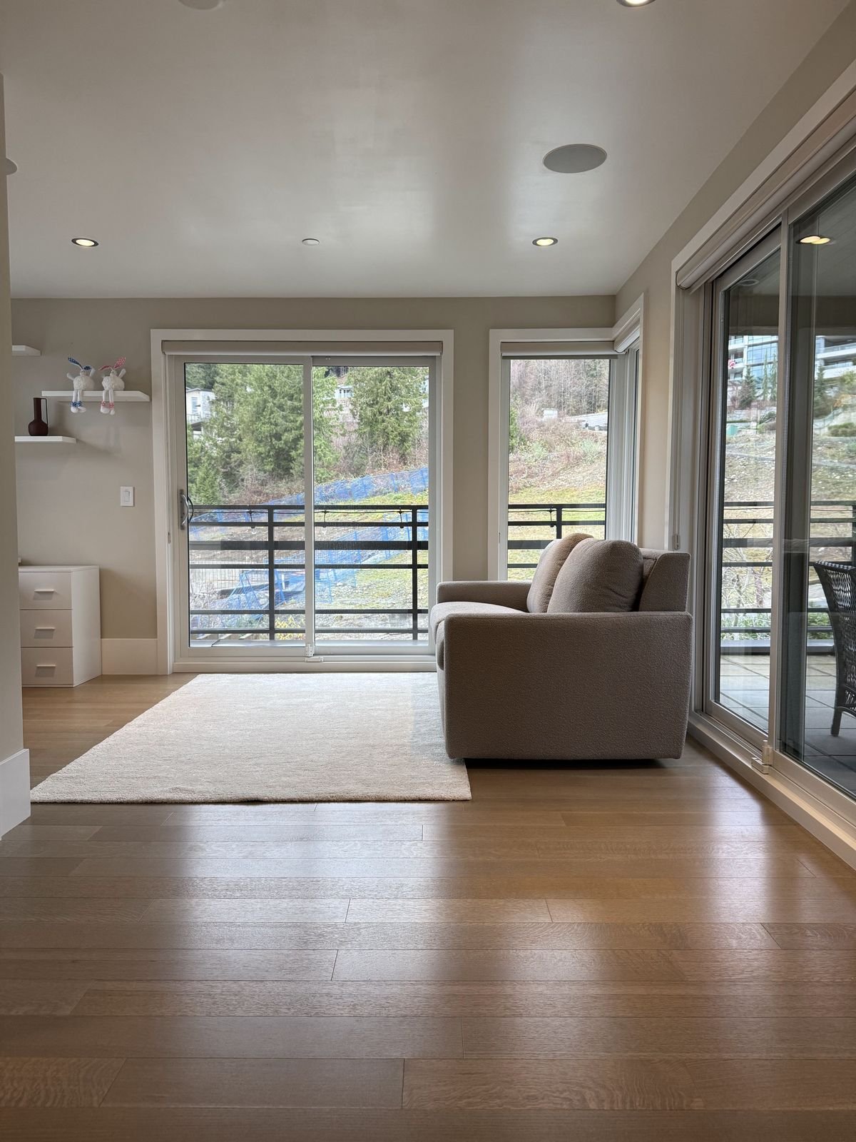 Loft converted into a bedroom with sliding doors to the deck in a West Vancouver home with a new ensuite