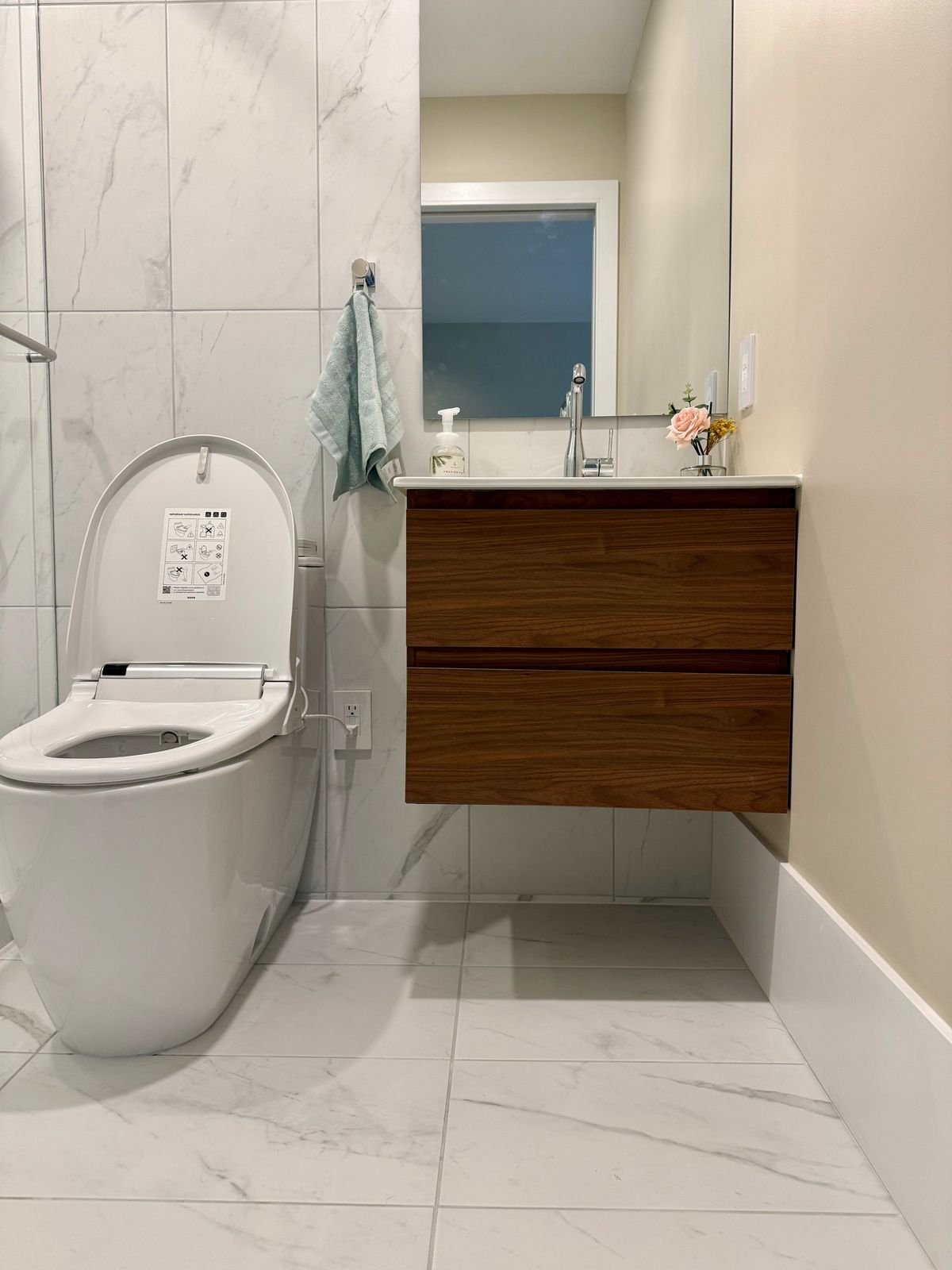 Walnut floating vanity, Grohe faucet and smart toilet in a new West Vancouver ensuite