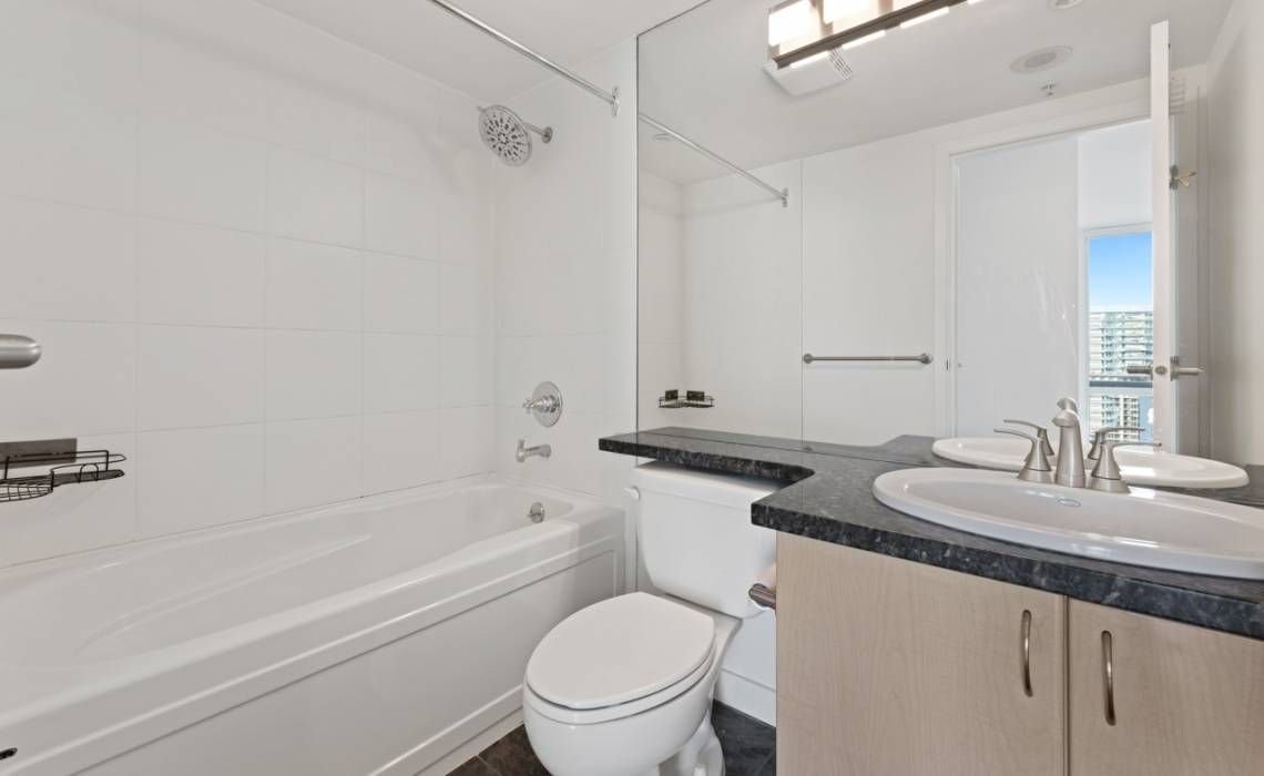 Before: original bathtub and surround in a Yaletown condo bathroom