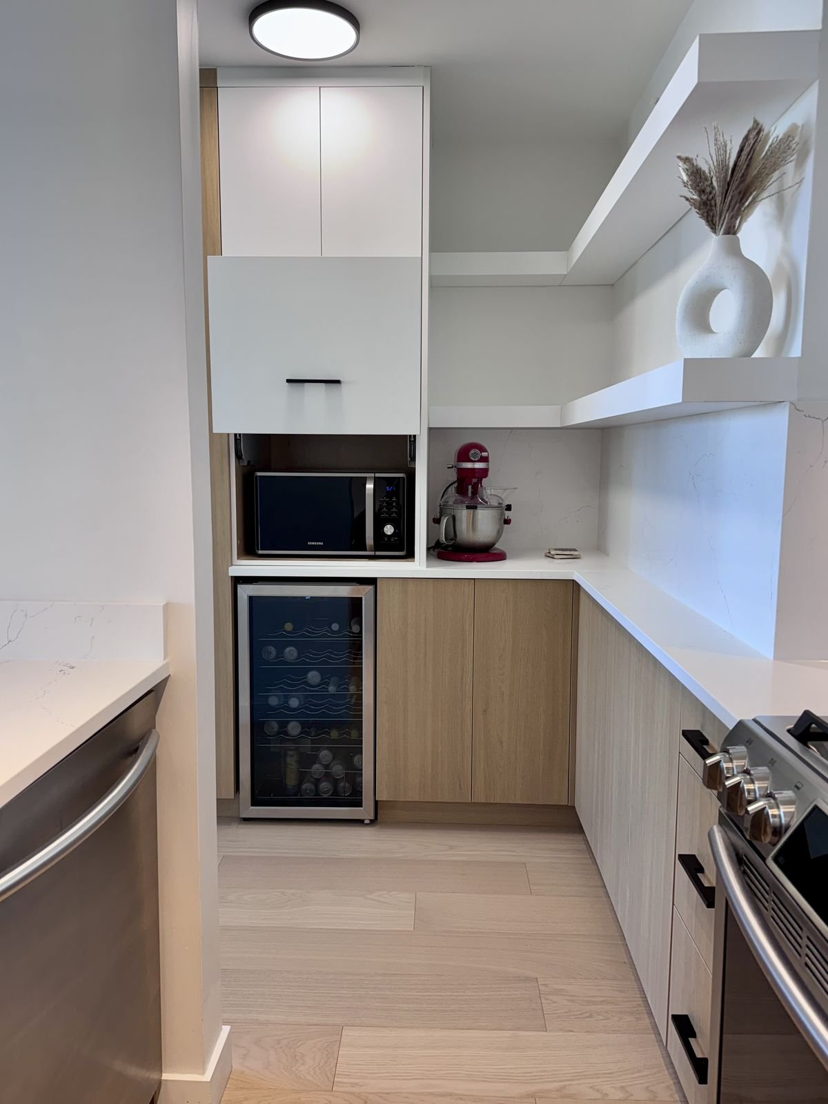 Appliance pantry with outlets and floating shelves in a renovated Yaletown condo kitchen