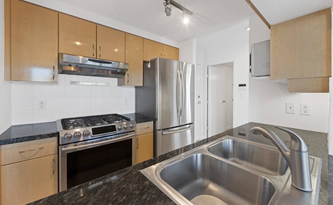 Before: original maple cabinets in a Yaletown condo kitchen